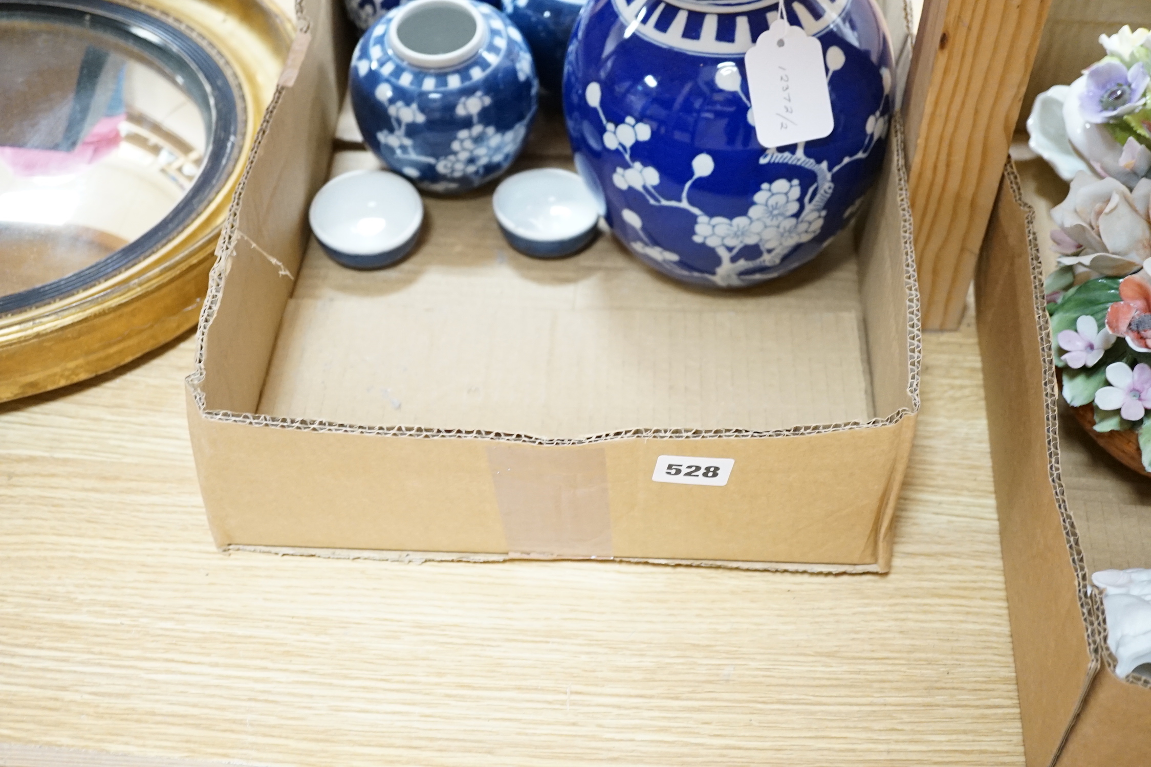 A small group of figurines and decorative ceramics, including four floral ceramic table displays